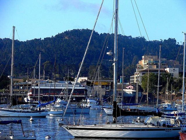 Boats in Monterey Harbor with downtown buildings beyond