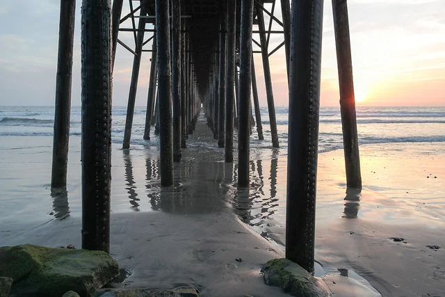 View beneath Oceanside Pier at sunset